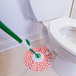 Libman mop head attached to green handle cleaning floor near a white toilet, patterned microfiber visible