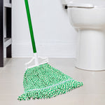 Libman green-and-white mop head attached to a handle positioned on a tiled bathroom floor near a toilet