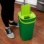Lifestyle photo of a person using a Libman green mop head inserted into the dual-chamber bucket on wood floor