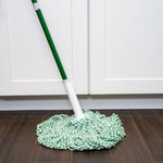 Libman mop assembled on a handle sitting on a wood floor in front of white cabinetry, showing mop head on floor