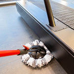 Libman microfiber spin mop refill engaged under treadmill base, showing gray and white twisted mop strands and black hub