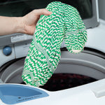 Hand holding a green-and-white twisted mop refill above a top-loading washer, showing washable fabric and attachment area