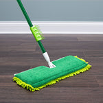 Green-handle mop with Libman-style green microfiber refill placed on a dark wood floor near baseboard