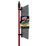 Packed Libman broom mounted vertically with retail label, red handle and visible grey bristle head on white background.