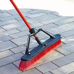 Libman push broom with red bristles on pavers showing close-up of handle bracket and bristles