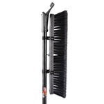 Close-up vertical shot of a Libman push broom head with dense black bristles and steel handle attachment