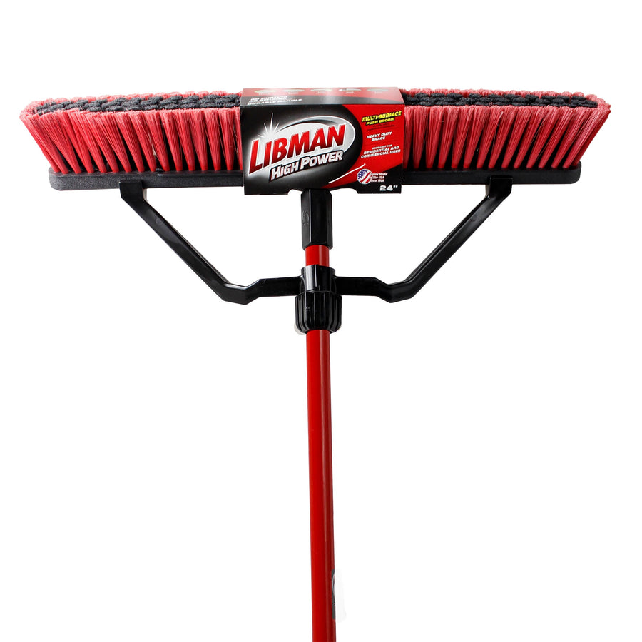 Front-facing red and black Libman push broom head with steel handle attached on white background