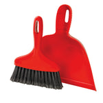 Red handheld whisk broom with black bristles paired with a red dustpan on white background