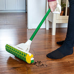 Roller mop with Libman honeycomb sponge head cleaning debris from a hardwood floor, user holding handle
