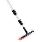 Angled close-up of a Libman telescopic pole showing textured black grips and the red-mesh sponge squeegee head.