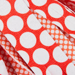 Macro shot of orange and white polka-dot patterned mop strips from a Libman Wonder Mop head