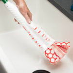 Close-up of hand holding Libman Wonder Mop handle and patterned mop head over a bathtub
