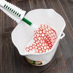 Libman Wonder Mop head with orange polka-dot pattern placed inside a white bucket on wood floor