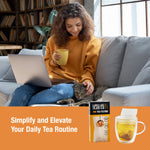Person on a couch holding a mug with a box of Tiesta Tea filters and a steeping cup shown in an orange lifestyle banner