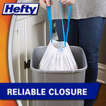 Drawstring white trash bag being lifted from a kitchen can by blue ties, showing reliable closure text and Hefty logo