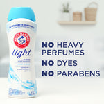 Arm & Hammer Light bottle on left with text to right listing ‘NO HEAVY PERFUMES NO DYES NO PARABENS’ on pale background