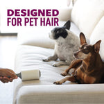 Person rolling a lint roller on a light sofa near two small dogs with text 'designed for pet hair'