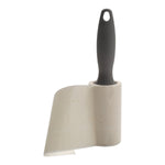 Gray-handled lint roller with sheet partially peeled away to show adhesive roll texture