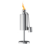 Stainless-steel table torch lamp lit with visible flame against a white background