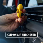Hand clipping a small yellow duck-shaped air freshener onto a car vent, overlaid text 'Clip On Air Freshener'