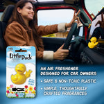 Driver smiling while a yellow duck air freshener is clipped to the car vent, product pack and feature text at left