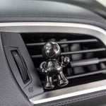 Black Little Joe car air freshener clipped to a vehicle air vent showing installation in car