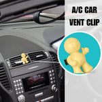 Car interior showing a small yellow Little Joe vent-clip on the air vent with an inset close-up of the clip
