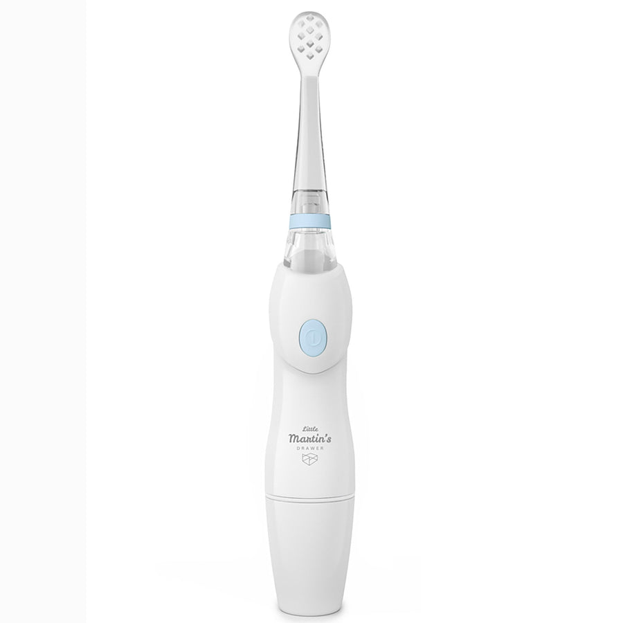 White baby electric toothbrush with light-blue power button and Little Martin's logo on white background