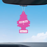 Pink Little Trees air freshener labeled 'Dragon Fruit' hanging from a car rearview mirror against a blue sky