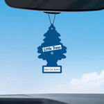 Blue Little Trees air freshener labeled 'New Car Scent' hanging from a rearview mirror against a clear sky background.