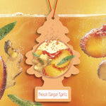 Close-up stylized Little Trees peach ginger spritz air freshener with peach and ginger graphics and bubbly background