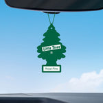 Little Trees Royal Pine air freshener hanging from a rearview mirror against a blue sky, label reads 'Royal Pine'