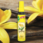 Little Trees Vanillaroma spray bottle staged against a background of vanilla flowers and pods