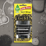 Little Trees Vent Wrap Gold package shown against a decorative grayscale lifestyle background