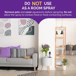Styled living room scene with text warning "Do Not Use As A Room Spray" and a Hot Shot can placed on a small table near flowers.