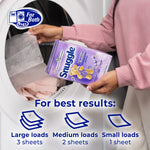 Hands loading a Snuggle Lavender Breeze box into a dryer with usage guidance icons for sheets per load
