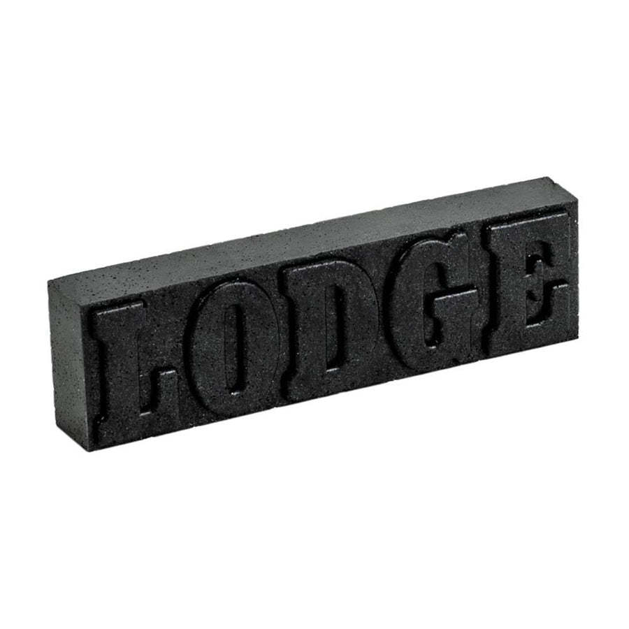 Black rectangular Lodge rust eraser bar with raised LODGE lettering on a white background