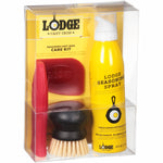 Clear retail boxed packaging of the Lodge Seasoned Cast Iron Care Kit showing the yellow seasoning spray, brush and red silicone tools inside.