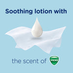 Close-up of a lotion droplet on a white tissue with text reading soothing lotion and Vicks logo on blue background