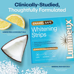 Flat-lay of Lumineux whitening strips box beside lemon wedge, coconut piece, and sea salt representing natural ingredients.