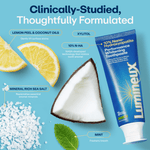 Flat-lay of Lumineux tube with lemon wedge, coconut piece, sea salt and mint leaf showing ingredient callouts and benefits.