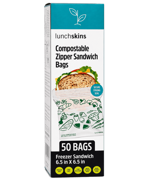 Tall product box of Lunchskins compostable zipper sandwich bags showing a bag with printed green icons and '50 BAGS' label.