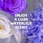 Macro floral arrangement in water with text overlay 'ENJOY A LUSH WATERLILY SCENT' in white rounded type