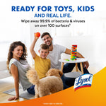 Family playing on the floor with a dog and a small table of toys, Lysol logo and headline about wiping away bacteria