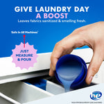 Hand pouring blue Lysol Laundry Sanitizer liquid from the cap into a washing machine dispenser with measurement graphic