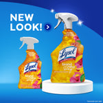 Large and small Lysol Brand New Day mango & hibiscus spray bottles on blue stage with text announcing new look
