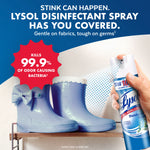 Hand holding a Lysol Disinfectant Spray can spraying near a pair of blue rubber boots with a red badge claiming 99.9% odor bacteria kill.