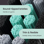 Macro image of round-tipped mint, grey, and black bristles with callouts about gentleness and flexibility