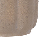Macro view of the tan planter's textured exterior showing speckled finish and molded vertical ridges.