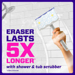 Hand holding a Magic Eraser attached to a scrubber handle over tiled shower with text claiming eraser lasts 5X longer